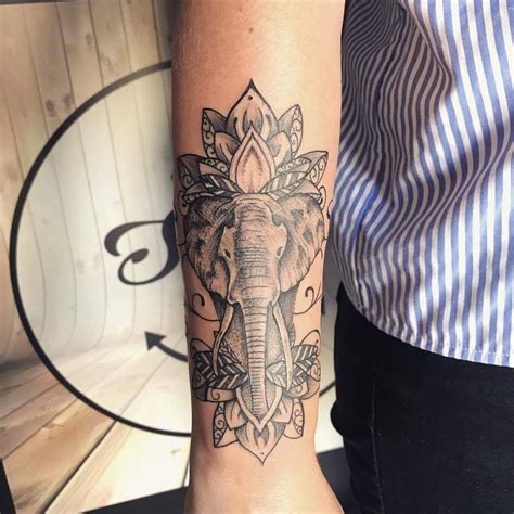 The lotus flower symbolizes beauty, and the mouse represents Ganeshs ability to overcome obstacles. . Elephant tattoo forearm